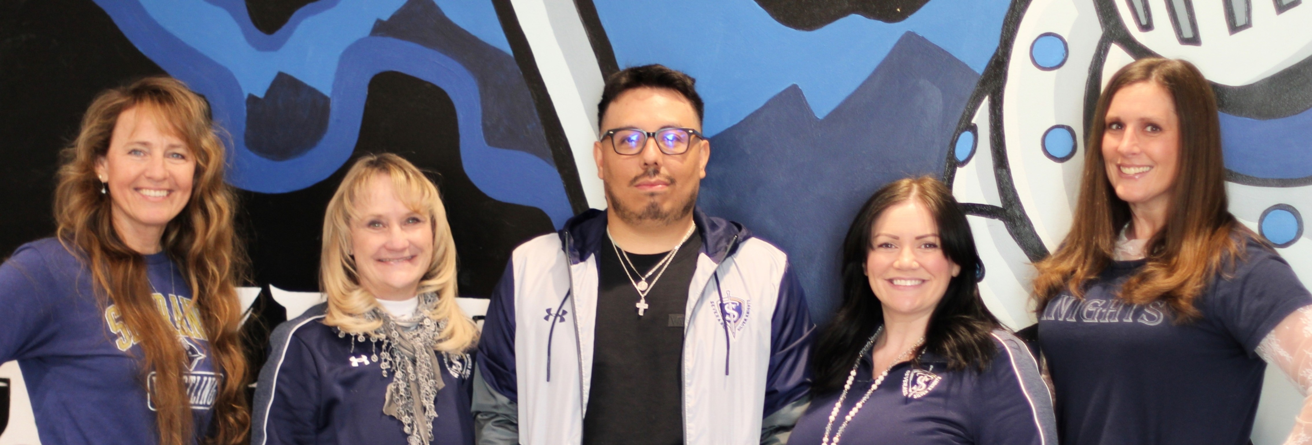 Student enters a building with a fist bump